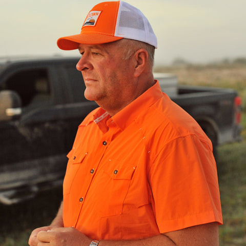 man on ranch wearing s/s blaze performance field shirt and blaze and white sundown hat