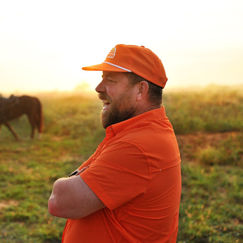 man on ranch wearing s/s blaze performance field shirt and blaze sundown hat