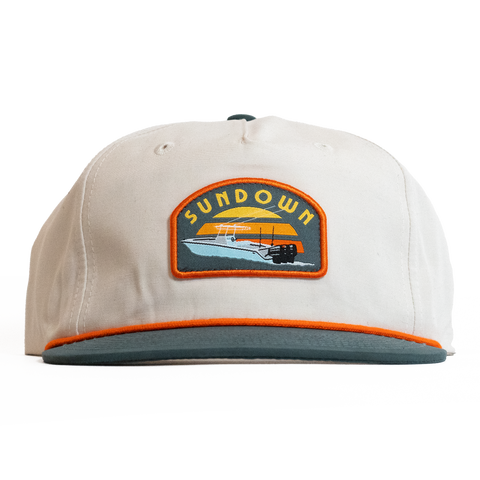 Beige cap with a Sundown logo on a white background