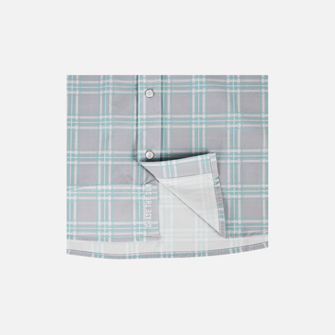 Closeup of bottom front of Seafoam/Grey Plaid Pearl Snap Field Shirt L/S showing White "CHASE THE SUN" text inside placket - Sundown Supply Co