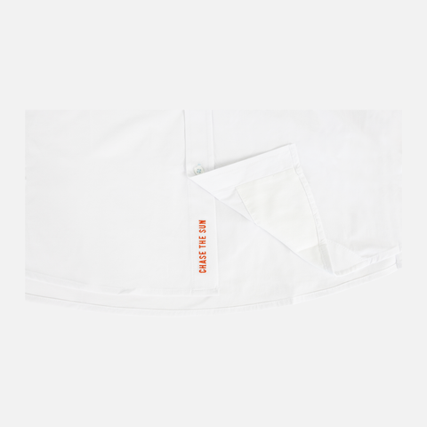 bottom of Long sleeve white performance field shirt showing "CHASE THE SUN" text inside where buttons meet - Sundown Supply Co