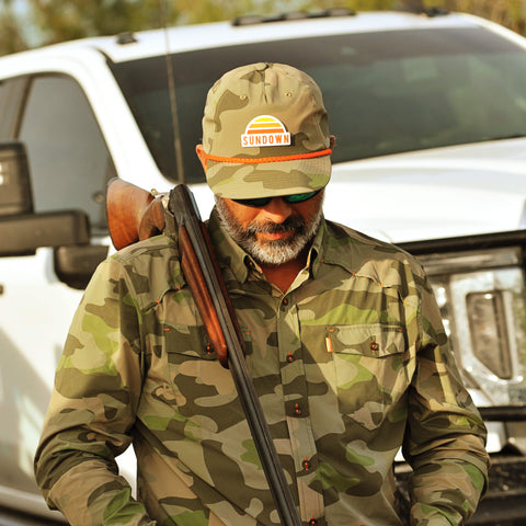 Man in camouflage clothing and cap - camo hunting shirts