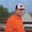 Orange/Navy/White Sundown Supply Meshback Snapback on man wearing orange long sleeve field shirt