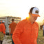 Man on ranch wearing Orange/Navy/White Sundown Supply Meshback Snapback