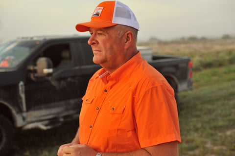 man on ranch wearing s/s blaze performance field shirt and blaze and white sundown hat