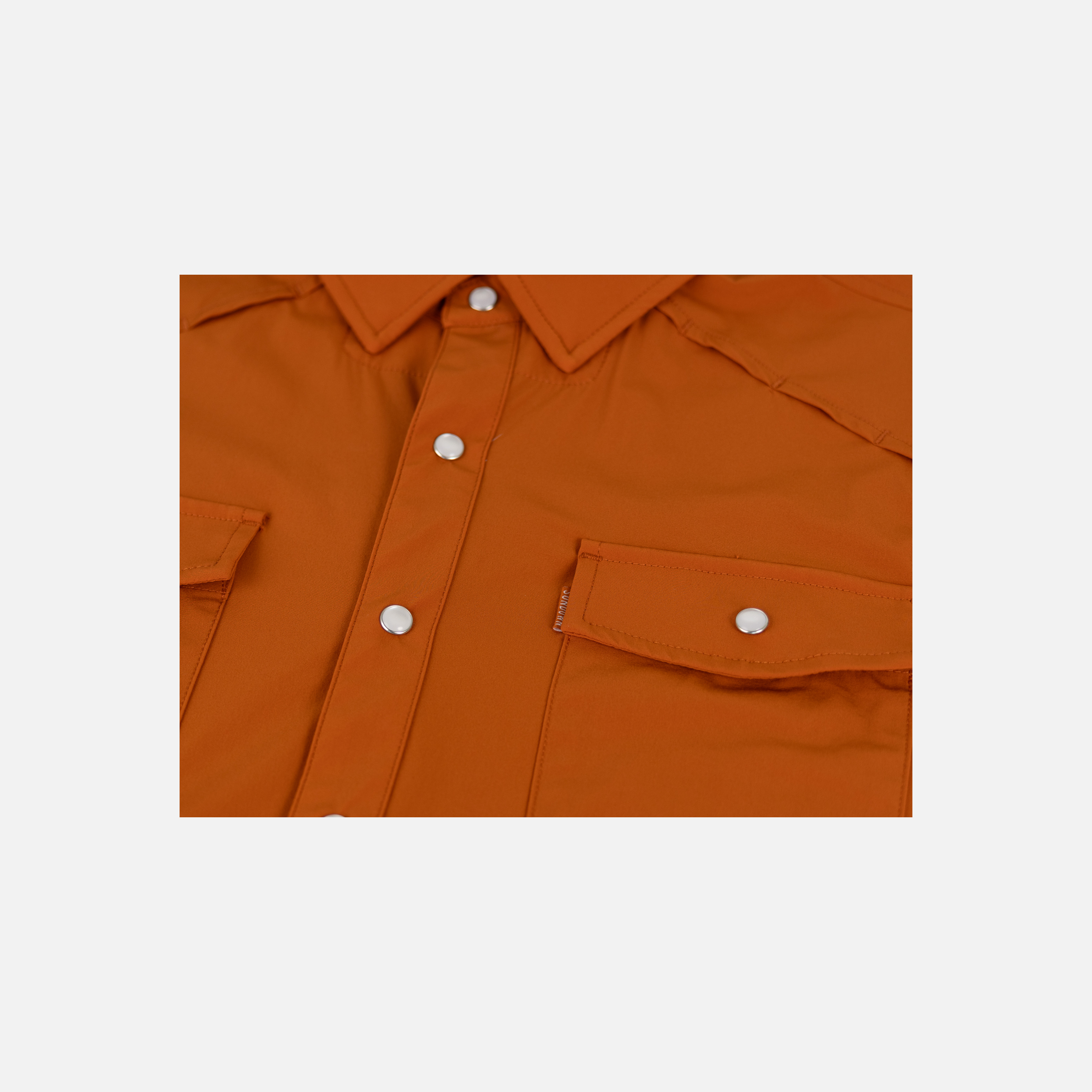 closeup of front buttons and pockets of Burnt Orange Pearl Snap Field Shirt L/S