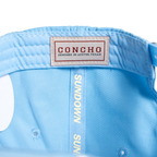 Light blue cap with 'Concho' label and 'Sundown Sun' text on a white background