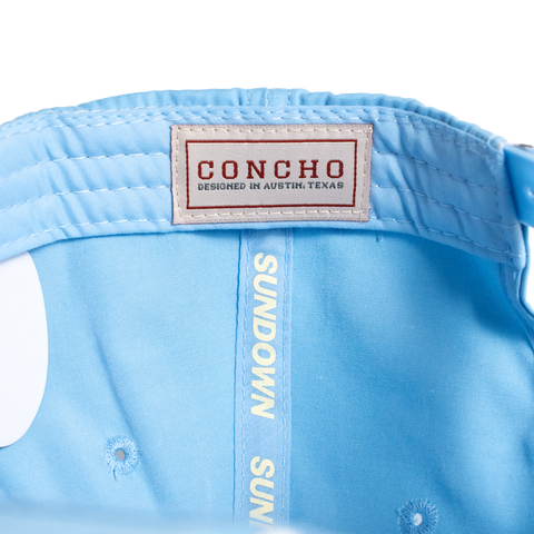 Light blue cap with 'Concho' label and 'Sundown Sun' text on a white background
