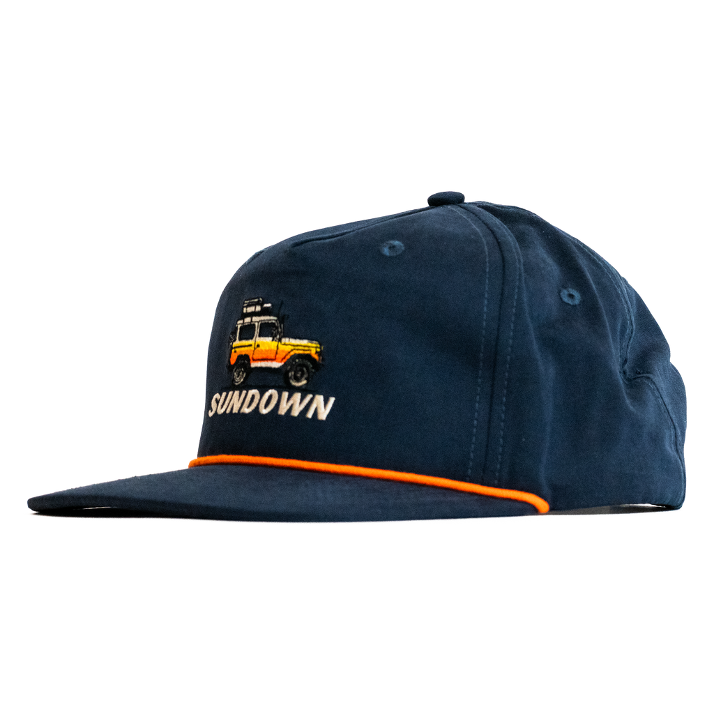 Navy blue cap with embroidered design and 'Sundown' text on a white background