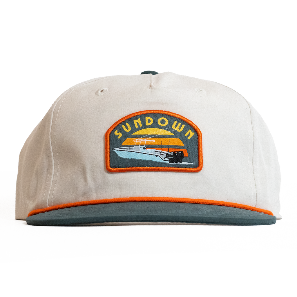 Beige cap with a Sundown logo on a white background