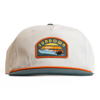 Beige cap with a Sundown logo on a white background