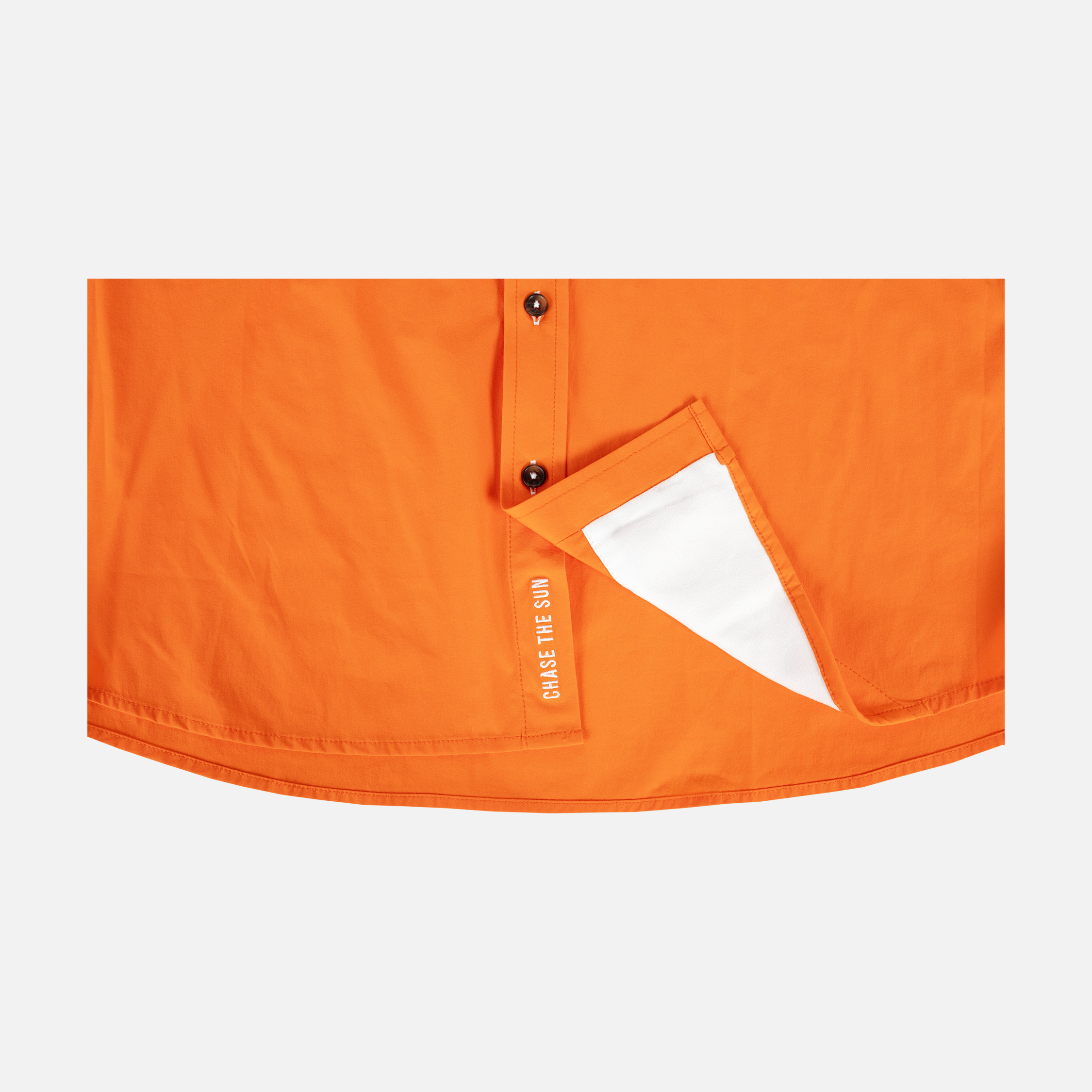 bottom of Long sleeve blaze performance field shirt showing "CHASE THE SUN" text inside where buttons meet - Sundown Supply Co