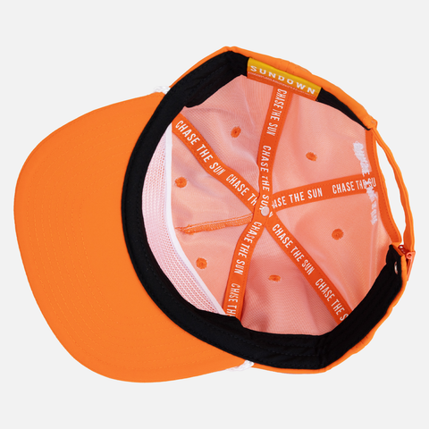 Interior view of rear view of Blaze Unstructured 5-Panel Rope Cap showing interior taping with white text "CHASE THE SUN"