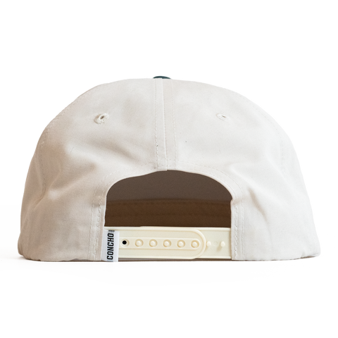 Back view of a beige cap with a brown patch and visible brand logo on a white background