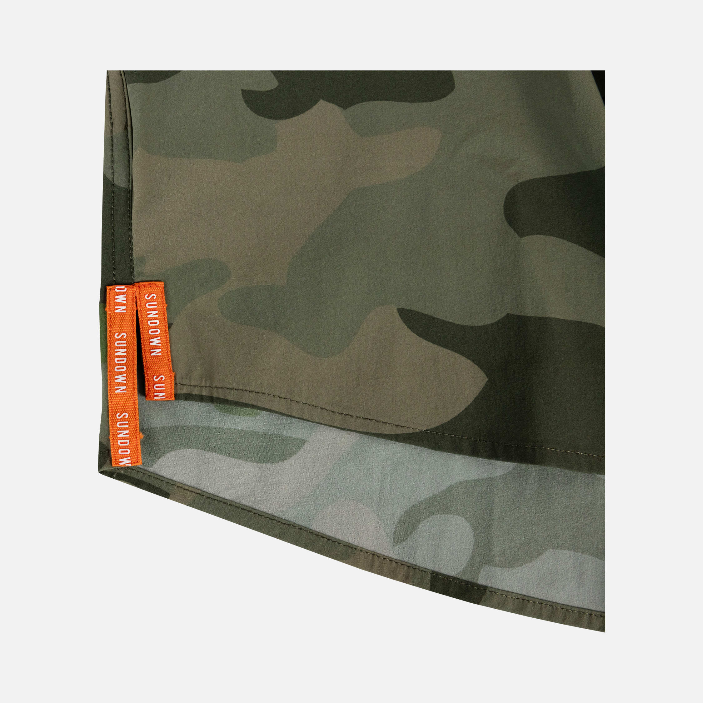 closeup of side vents on bottom side of s/s Vintage Camo performance field shirt with white embroidered "SUNDOWN" text