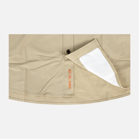 bottom of Long sleeve Khaki performance field shirt showing "CHASE THE SUN" text inside where buttons meet