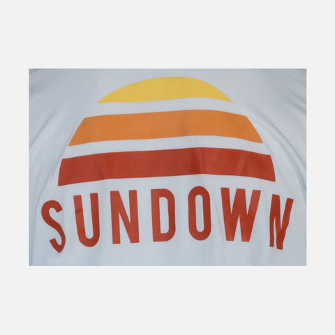 closeup of back of l/s Faded sky logo bamboo sun hoodie with front pocket showing large orange Sundown logo and "SUNDOWN" text