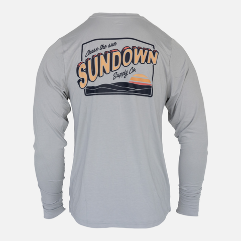 rear view of Grey Greetings Bamboo Sun Crew L/S showing sundown graphic on upper back with text "Chase the sun SUNDOWN Supply Co"