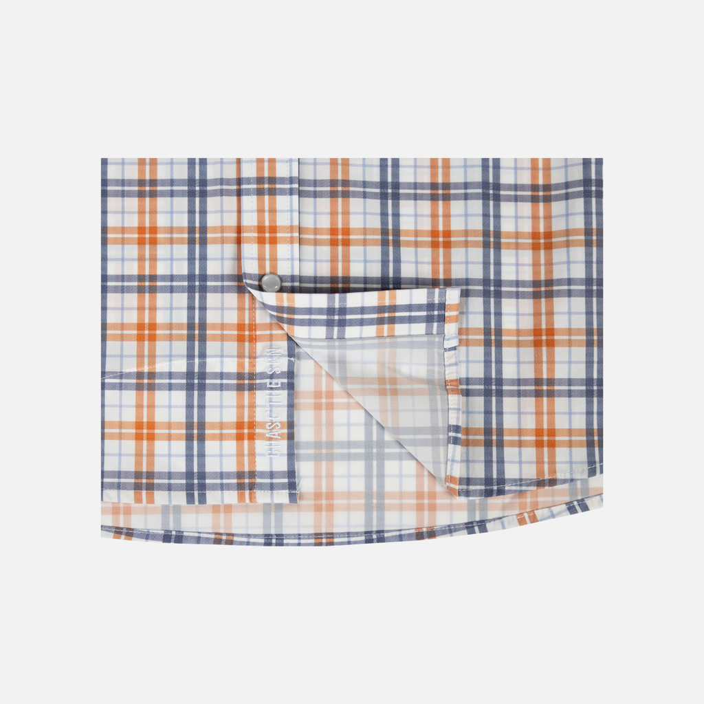 Closeup of bottom front of Orange/Navy Plaid Pearl Snap Field Shirt L/S showing White "CHASE THE SUN" text inside placket- Sundown Supply Co