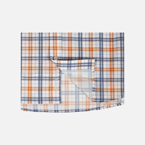 Closeup of bottom front of Orange/Navy Plaid Pearl Snap Field Shirt S/S showing White "CHASE THE SUN" text inside placket