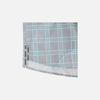 Closeup of bottom side edge of Seafoam/Grey Plaid Pearl Snap Field Shirt S/S showing grey side slits with black "SUNDOWN" text