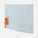 closeup of side seam of Long sleeve faded sky performance field shirt showing text "SUNDOWN"