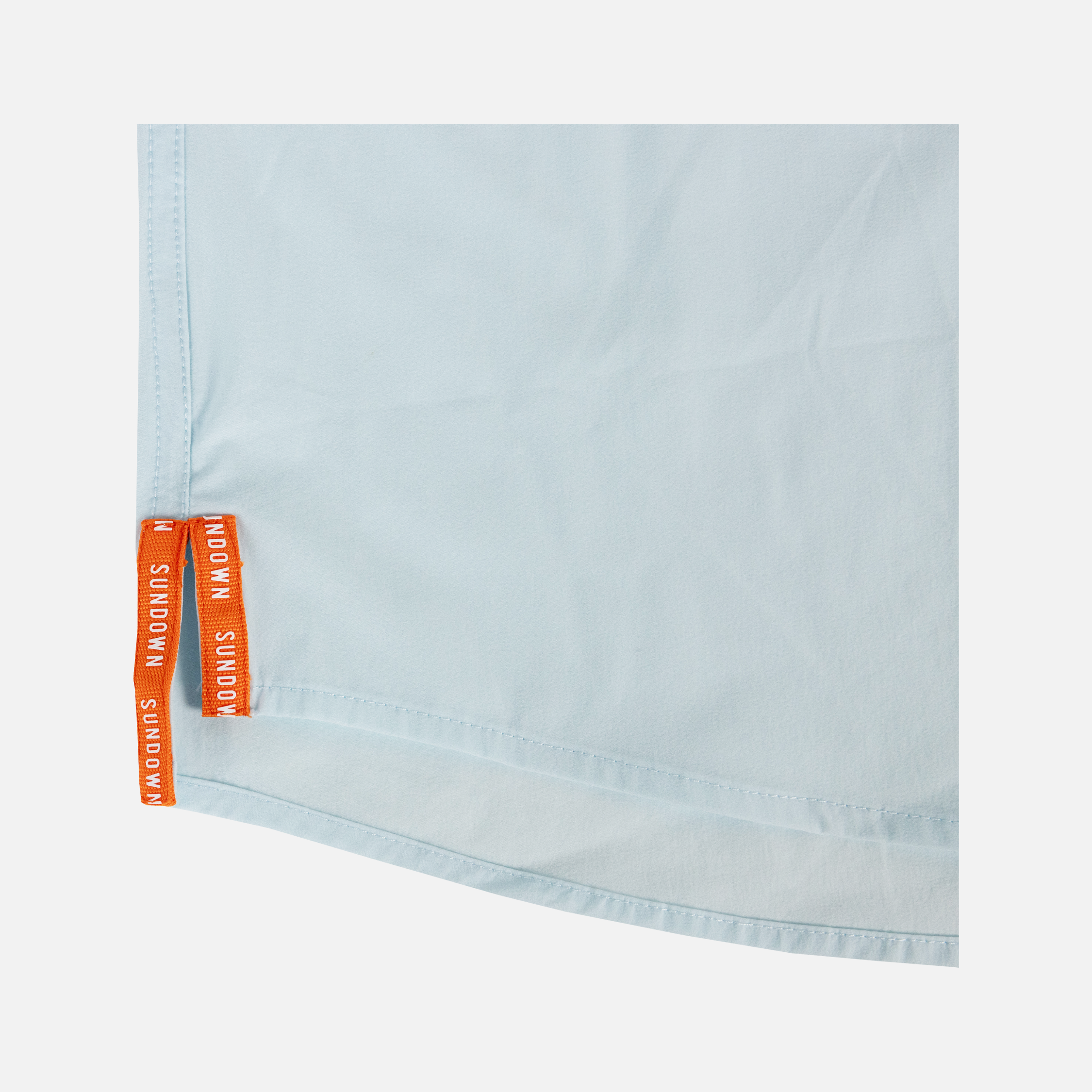 closeup of side seam of Long sleeve faded sky performance field shirt showing text "SUNDOWN"