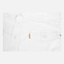 closeup of chest of white performance field shirt short sleeve showing front pocket with orange sundown label