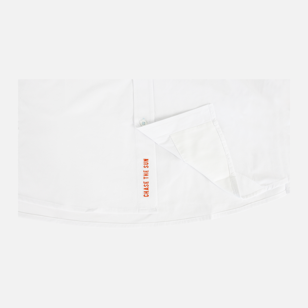 loseup of blaze "chase the sun" embroidered text on interior buttons of white s/s performance field shirt